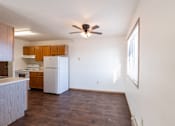 Thumbnail 9 of 17 - A kitchen with white appliances and wooden cabinets. Fargo, ND Fieldstone Apartments