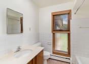 Thumbnail 8 of 19 - a bathroom with a sink toilet and a window.  Golden Valley, MN Valley View Apartments