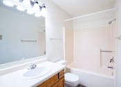 Thumbnail 12 of 17 - A white bathroom with a sink, toilet and bathtub. Fargo, ND Southgate Apartments