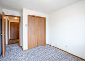 Thumbnail 11 of 17 - A room with a carpeted floor and a white wall. Fargo, ND Southgate Apartments