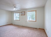 Thumbnail 19 of 23 - A room with a carpet floor, a ceiling fan, and two windows. Fargo, ND Summit Point