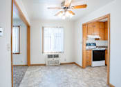 Thumbnail 6 of 12 - A room with a ceiling fan and a window with blinds. Fargo, ND L&R Apartments