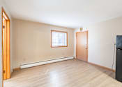 Thumbnail 2 of 7 - A room with a window and a door. Fargo, ND Birchwood Apartments