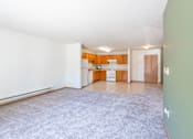 Thumbnail 36 of 54 - A room with a carpeted floor and a door leading to another room. Fargo, ND Stonebridge Apartments