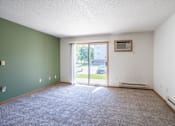 Thumbnail 35 of 54 - A room with a carpeted floor and a window with a view of the outside. Fargo, ND Stonebridge Apartments