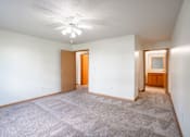 Thumbnail 23 of 54 - A room with a carpeted floor and a ceiling fan. Fargo, ND Stonebridge Apartments