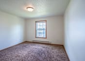 Thumbnail 13 of 54 - A room with a window and a carpet on the floor. Fargo, ND Stonebridge Apartments