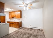 Thumbnail 30 of 34 - A room with a ceiling fan and a rug on the floor. Fargo, ND Islander Apartments