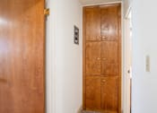 Thumbnail 33 of 34 - A brown wooden door with a handle and a lock. Fargo, ND Islander Apartments