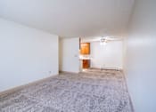 Thumbnail 27 of 34 - A room with a carpeted floor and a small wooden cabinet. Fargo, ND Islander Apartments