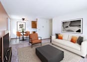 Thumbnail 2 of 10 - A living room with a white couch and a black coffee table.  Fargo, ND Carr Apartments