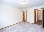 Thumbnail 18 of 42 - A room with a carpeted floor and two doors. Fargo, ND Westwood Estates