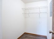 Thumbnail 21 of 42 - A white wall with a door and a shelf. Fargo, ND Westwood Estates