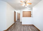 Thumbnail 14 of 42 - A long hallway with a fan and wood floors. Fargo, ND Westwood Estates