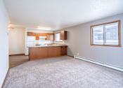 Thumbnail 11 of 42 - A kitchen area with a counter and a window. Fargo, ND Westwood Estates