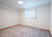 Thumbnail 37 of 46 - A room with a window and a carpeted floor. Cherry Creek Apartments
