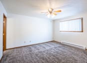 Thumbnail 15 of 20 - A room with a ceiling fan and a window with blinds. Fargo, ND Kennedy Apartments