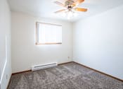 Thumbnail 17 of 20 - A room with a ceiling fan and a window with blinds. Fargo, ND Kennedy Apartments