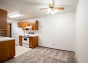 Thumbnail 17 of 23 - A kitchen with wooden cabinets and a white oven.