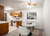Thumbnail 2 of 23 - A kitchen with a table and chairs and a framed picture on the wall. Fargo, ND Countryside Apartments