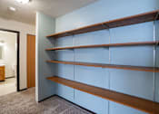 Thumbnail 20 of 23 - A wall of shelves in a room.