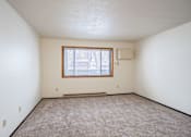 Thumbnail 13 of 23 - A room with a window and a bench.
