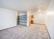 Thumbnail 14 of 23 - A room with a carpeted floor and a ceiling fan.