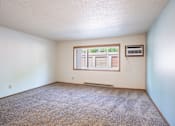 Thumbnail 18 of 21 - A room with a window and a carpet on the floor. Fargo, ND West Oak Apartments