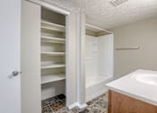 Thumbnail 34 of 34 - A white bathroom with a walk-in shower and a white sink. Omaha, NE Evergreen Terrace Apartments