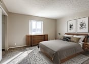 Thumbnail 4 of 34 - A bedroom with a bed, nightstand, and two framed pictures on the wall. Omaha, NE Evergreen Terrace Apartments