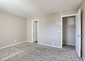 Thumbnail 32 of 34 - A room with carpeted floor and two doors. Omaha, NE Evergreen Terrace Apartments