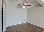Thumbnail 29 of 34 - A room with a ceiling fan and wooden flooring. Omaha, NE Evergreen Terrace Apartments