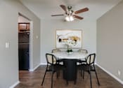 Thumbnail 3 of 34 - A dining room with a table set for four. Omaha, NE Evergreen Terrace Apartments