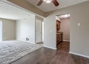 Thumbnail 28 of 34 - A room with a ceiling fan and wooden floors. Omaha, NE Evergreen Terrace Apartments