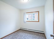 Thumbnail 19 of 39 - A room with a window and a carpeted floor. Grand Forks, ND Columbia West Apartments
