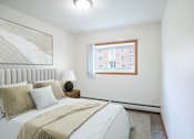 Thumbnail 4 of 39 - A bedroom with a large bed and a window. Grand Forks, ND Columbia West Apartments
