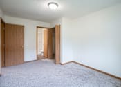Thumbnail 18 of 39 - A room with carpeted floor and two doors. Grand Forks, ND Columbia West Apartments
