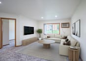 Thumbnail 1 of 39 - A living room with a couch, a coffee table, and a television. Grand Forks, ND Columbia West Apartments