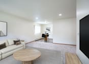 Thumbnail 2 of 39 - A living room with a white couch and a wooden coffee table. Grand Forks, ND Columbia West Apartments