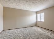 Thumbnail 22 of 29 - A room with a window and carpeted floor. Omaha, NE Stony Brook Apartments