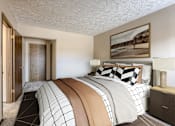 Thumbnail 4 of 29 - A bedroom with a large bed and a painting on the wall. Omaha, NE Stony Brook Apartments