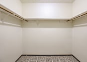 Thumbnail 24 of 29 - A small, empty room with a carpeted floor and two shelves. Omaha, NE Stony Brook Apartments