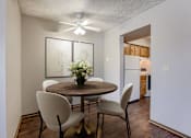 Thumbnail 3 of 29 - A dining room with a round table and chairs. Omaha, NE Stony Brook Apartments