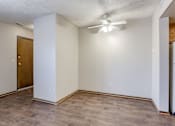 Thumbnail 20 of 29 - A room with a ceiling fan and a door. Omaha, NE Stony Brook Apartments