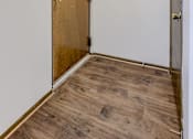 Thumbnail 28 of 29 - A room with a wooden door and a light on the ceiling. Omaha, NE Stony Brook Apartments