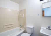 Thumbnail 19 of 20 - A white toilet sits next to a bathtub in a bathroom. Fargo, ND Morningside Apartments