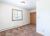 Thumbnail 17 of 20 - A room with a window and carpeted floor. Fargo, ND Morningside Apartments