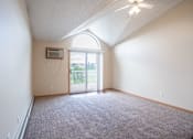 Thumbnail 9 of 43 - A room with a carpeted floor and a ceiling fan. Bismarck, ND Sierra Ridge Apartments