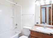 Thumbnail 29 of 30 - A white bathroom with a toilet, sink, and bathtub. Fargo, ND Long Island Apartments