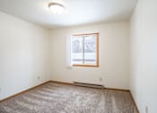 Thumbnail 23 of 30 - A room with a carpeted floor and a window. Fargo, ND Long Island Apartments